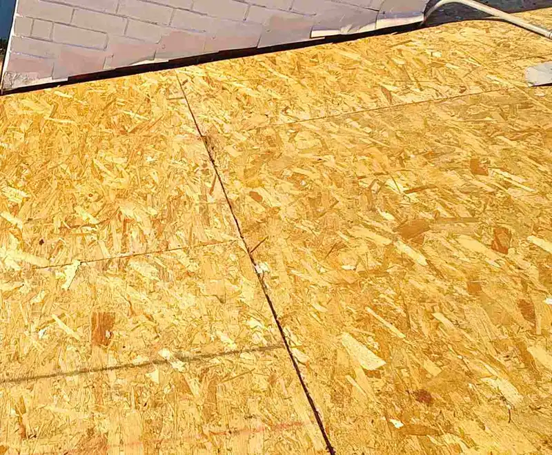 Exposed roof sheathing around a masonry chimney