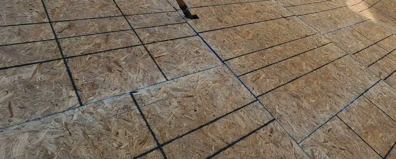 Layout lines across exposed roof sheathing