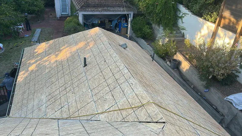 Exposed OSB roof decking with marked lines and penetrations
