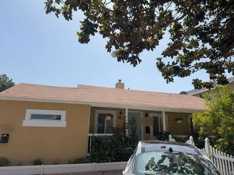 Pinkish asphalt shingle roof on front elevation