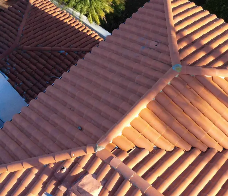 Curved roof tiles across intersecting roof planes
